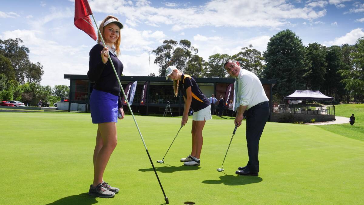 NEW EVENT: NSW deputy premier John Barilaro, tests his putting skill against sisters Chloe, (on the left holding flag) and Amber Thornton after announcing Queanbeyan Golf Club will host the 2019 Women's NSW Open. Photo: David Tease