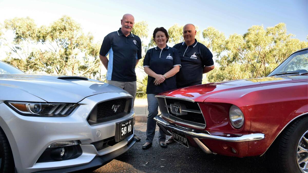 Canberra Mustang club members, from left, Mick Dainer, Sue Vilardi and Dominic Vilardi, with their cars. Photo: David Ellery.