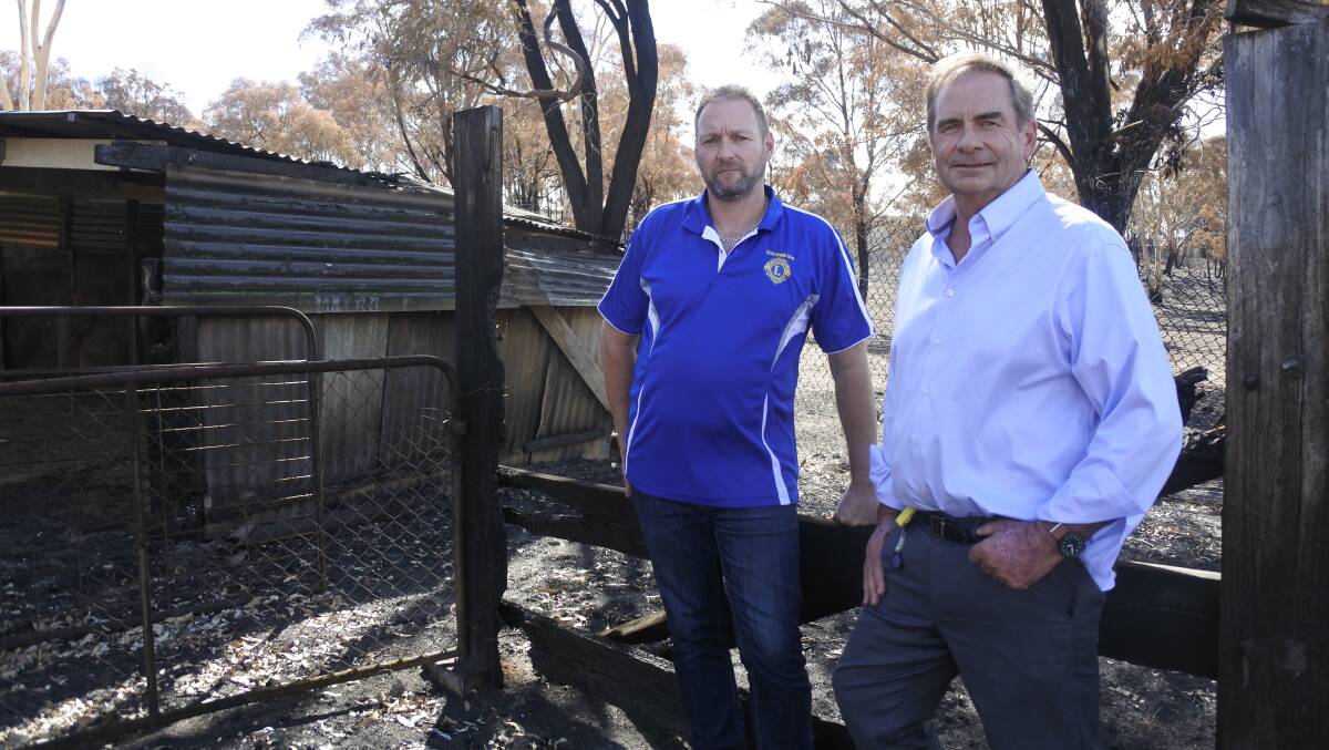 Queanbeyan Lions Club president Jamie Walker (left) has donated $20,000 on behalf of the club to the Queanbeyan-Palerang Regional Council's Carwoola Bushfire Appeal, organised by council administrator Tim Overall (right). Photo: Clare Sibthorpe
