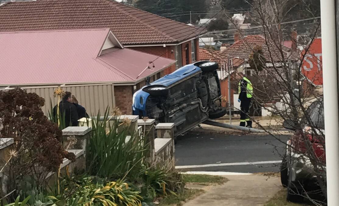 Car flips on side after accident