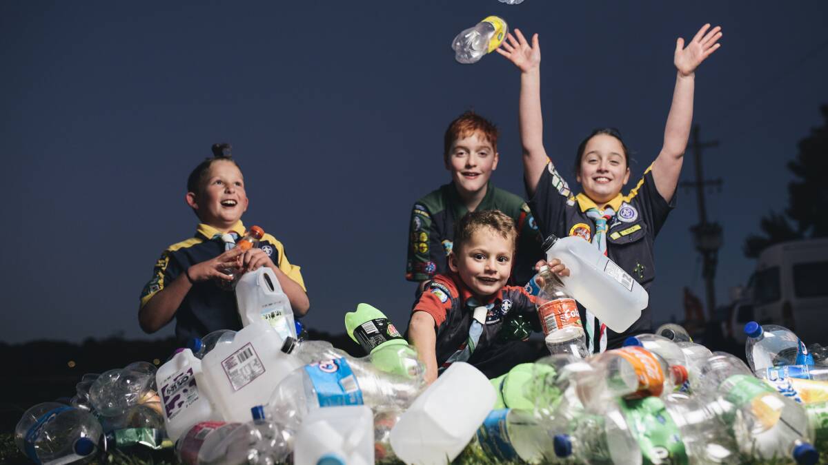 CASH FOR CANS: Lake Ginninderra scouts Eli Georgiou, 8, Adrian Lehane, 12, Oliver Georgiou, 6, and Bridget Lehane, 10, with a pile of bottles and cans. Photo: Rohan Thomson