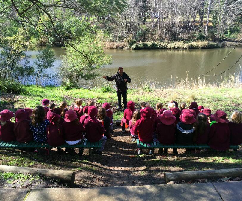 RIVETED: Adrian Brown utilises the outdoor classroom on the banks of the river to teach students about the connection between the Ngunnawal people and the water.