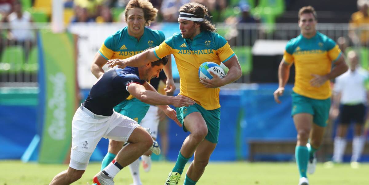 BRAIDWOOD BOY: Lewis Holland is tackled during the Men's Rugby Sevens Pool B match between Australia and France on Day 4 of the Rio 2016 Olympic Games at Deodoro Stadium on August 9. Photo: David Rogers/Getty Images