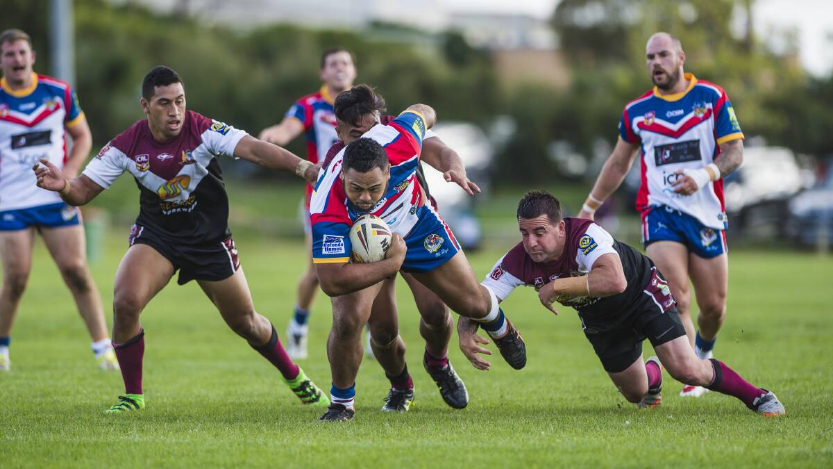 STRONG DEFENCE: Tuggeranong Bushrangers' Michael Uluakiola tries to batter his way through the Kangaroos' defence. Photo: Sitthixay Ditthavong.