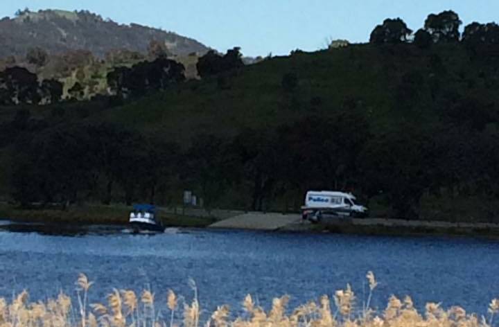 RESCUE: A woman in a canoe has rescued a man at Googong Dam. Photo: Facebook/ Monaro LAC.