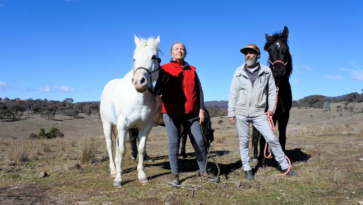 Kerrie and Russell Whitford, with their horses, are concerned about the drone testing. Photo: Elliot Williams.