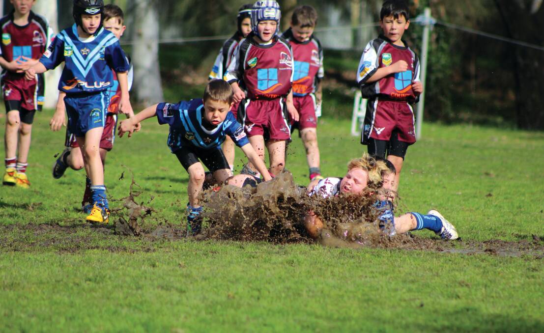 MUDDY DELIGHT: Under 9s playing football on a winter's day in Canberra. Photo: Trisha Sullivan, of Queanbeyan.