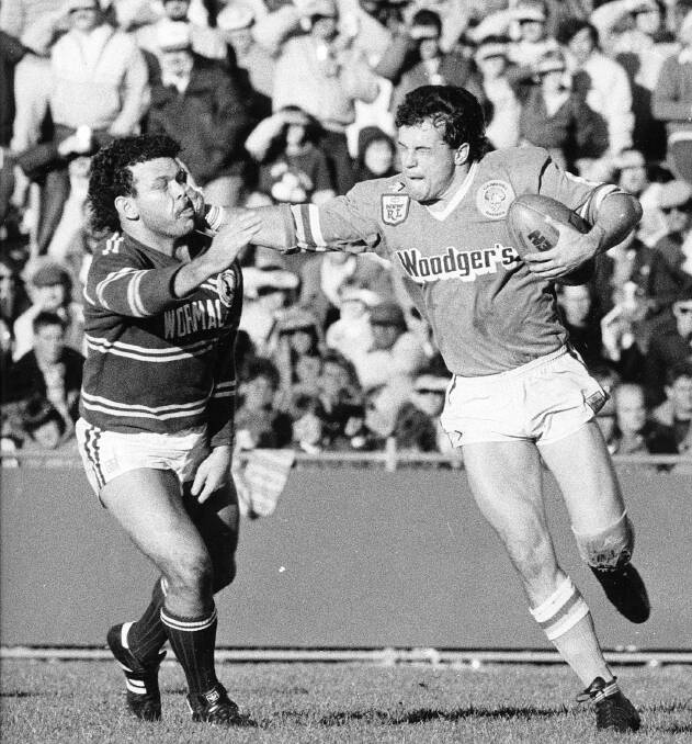 HISTORY IN THE MAKING: Canberra Raiders Dean Lance puts a fend on Manly Sea Eagles player Cliff Lyons at Seiffert Oval on June 8, 1986. Photo: Peter Wells.