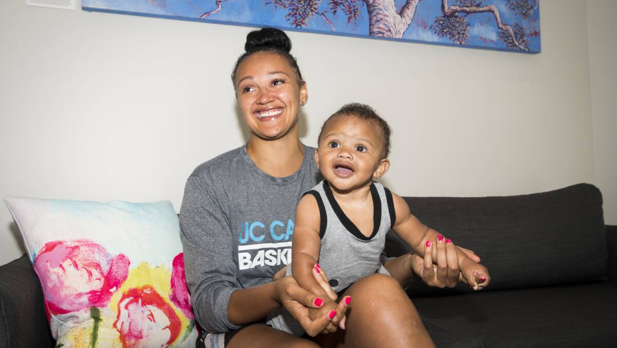 University of Canberra Capitals import Mistie Bass and her son Braven Boyd donate baby clothes and toys to Karinya House before returning home to the United States. Photo: Dion Georgopoulos