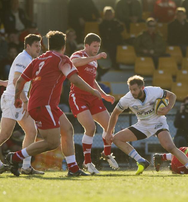 HELD OFF: Whites Robbie Coleman comes up against a wall of Vikings. Photo: Jay Cronan.