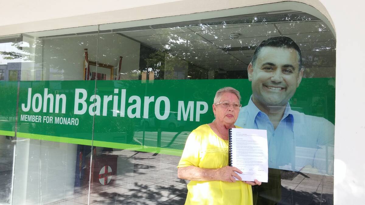 SIGNED, SEALED, DELIVERED: Yvonne Cuschieri delivers the petition of about 2000 signatures to John Barilaro's office in Queanbeyan. Photo: Supplied.