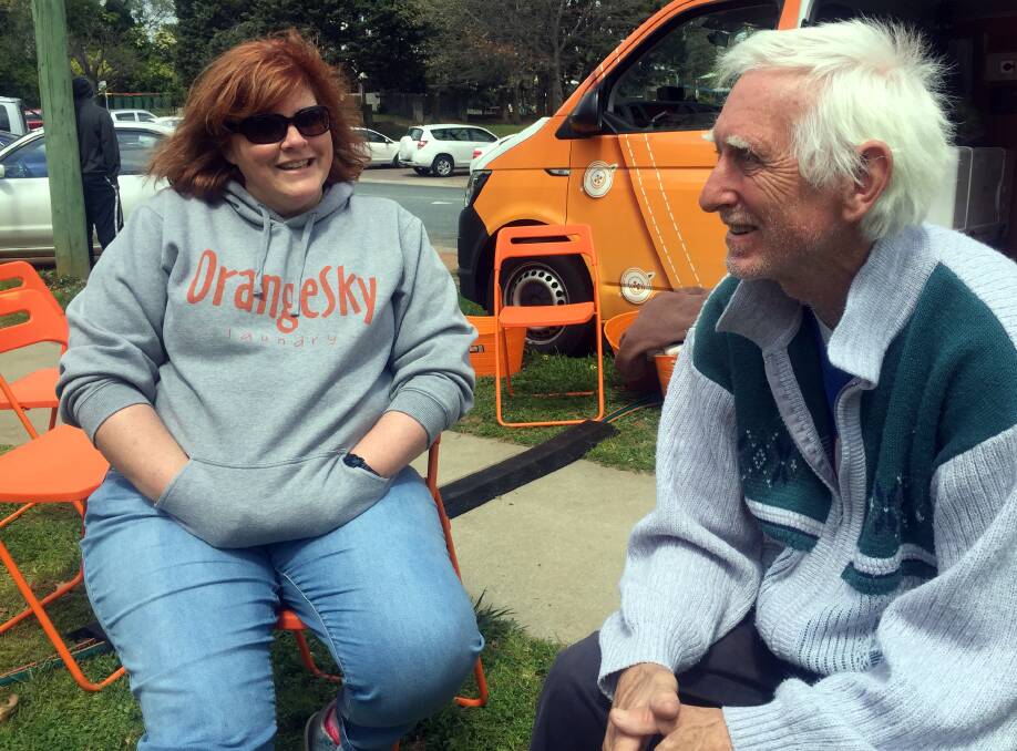 ORANGE SKY: Volunteer Tig Hall with laundry user Robert Jenkins. The pair have formed a friendship through Orange Sky. Photo: Kimberley Le Lievre.