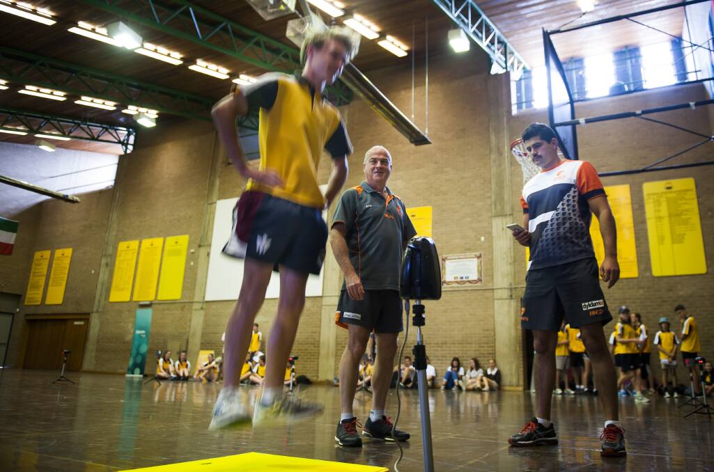 HIGH JUMP: Jackson Mailes, 15, of Karabar, takes part in the ActewAGL GIANT Opportunities Talent Search Program as it gets underway at Karabar High School with academy director John Quinn and talent identification phd student Andrew Sharp. Photo: Elesa Kurtz.