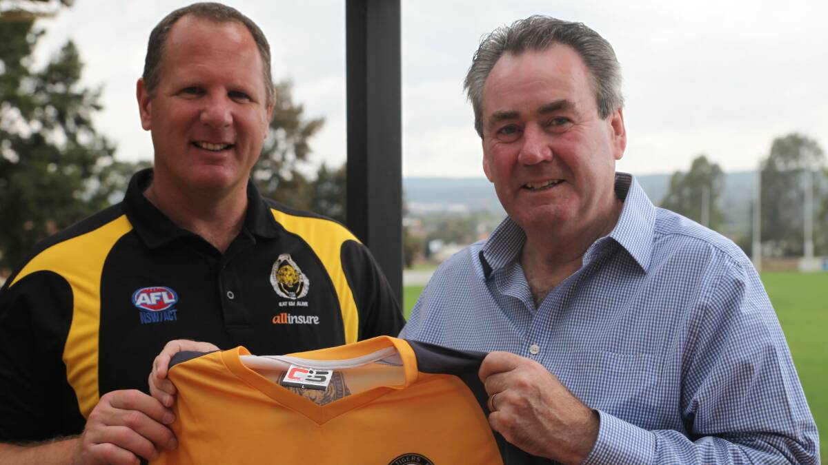 HIKING GEAR: Paul Walshe, pictured with Queanbeyan Tigers general manager Michael Goiser, will wear his former football club's jumper during his hike along the Kokoda Trail. Photo: James Hall.