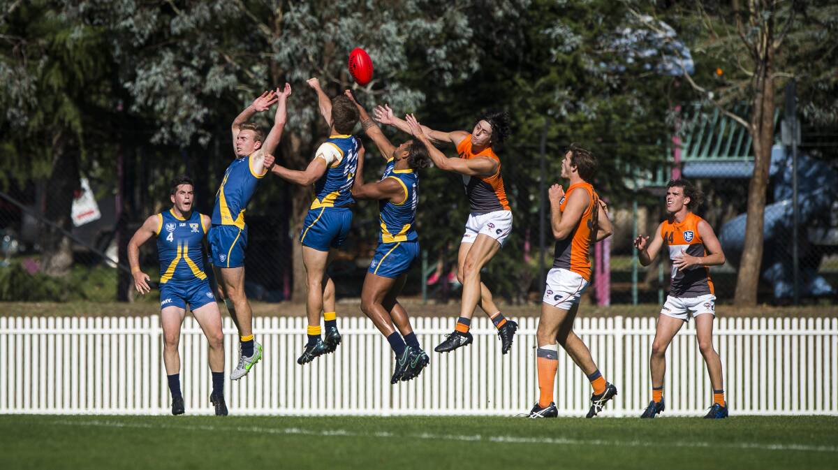 CANBERRA DEMONS: Both teams scrambling to the ball. Photo: Dion Georgopoulos.