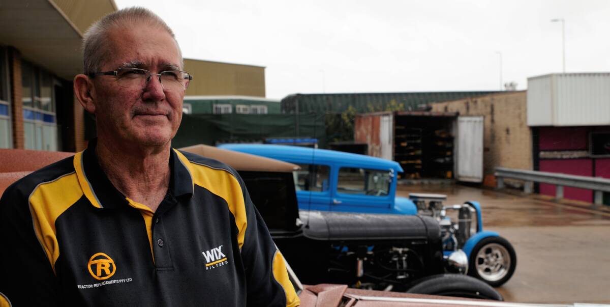 HOT RODS: Graeme Thomas with a selection of vintage American cars that will be on show in Queanbeyan on Saturday. Photo: James Hall.