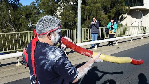The sound of the didgeridoo mixed with children playing during the Reconciliation walk through Queanbeyan. Photo: James Hall.