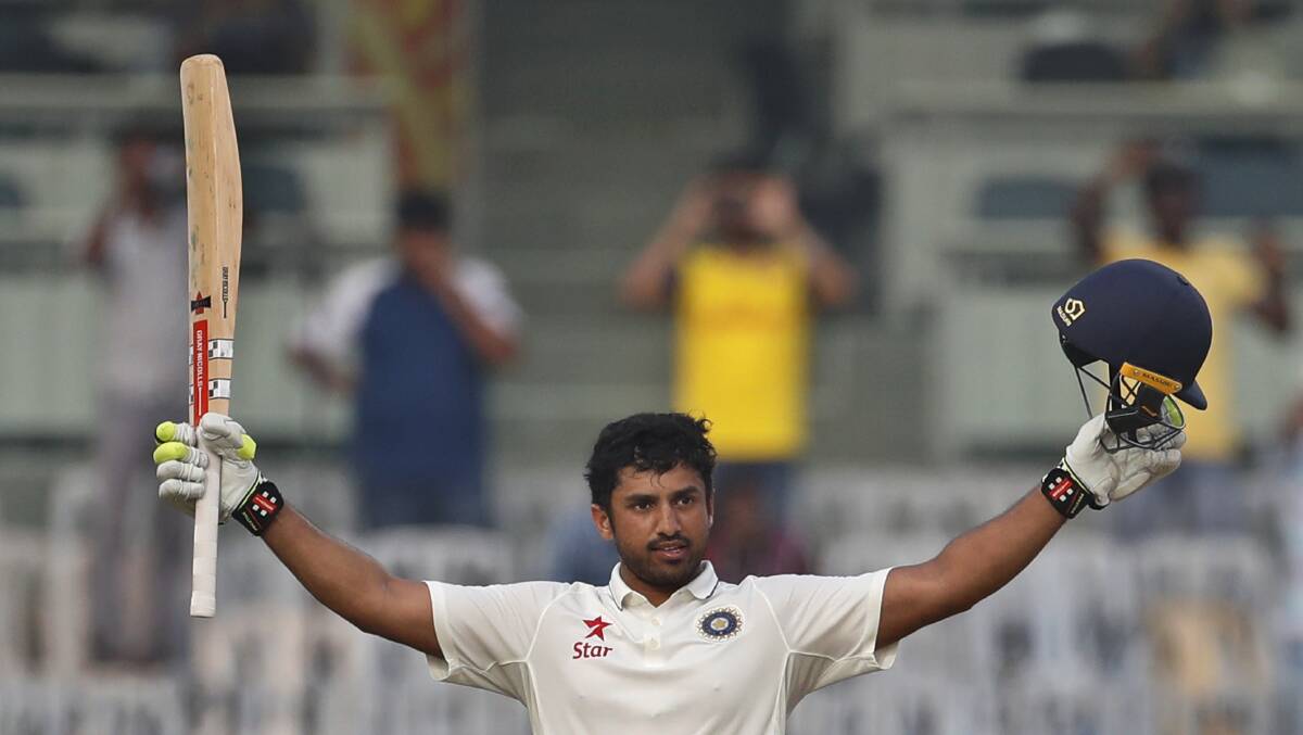 CRICKET: India's Karun Nair raises his bat after scoring three hundred runs against England during their fourth day of the fifth cricket test match in Chennai. Photo: AP/Tsering Topgyal.