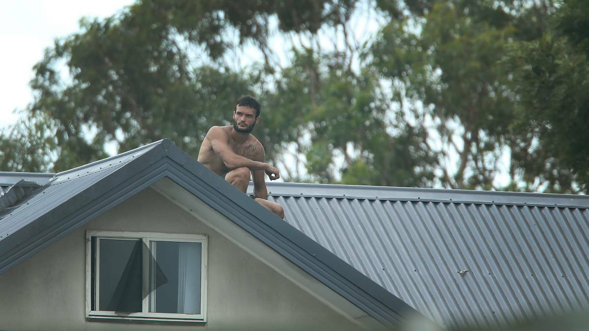Ricky Kincheila, of Wallsend, on top of the apartment block in Tighes Hill on Tuesday. Picture: Marina Neil