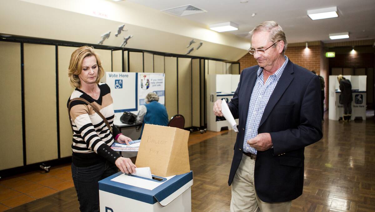 Former Mayor Tim Overall casts his ballot with wife Nichole Overall at Bicentennial Hall. Photo: Jamila Toderas