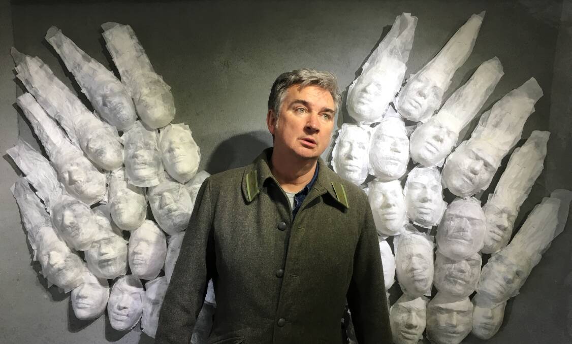 Damian Callinan, pictured here in front of Karyn Fearnside's artwork at Form Studio and Gallery, will perform at The Q on Saturday. Photo: Supplied