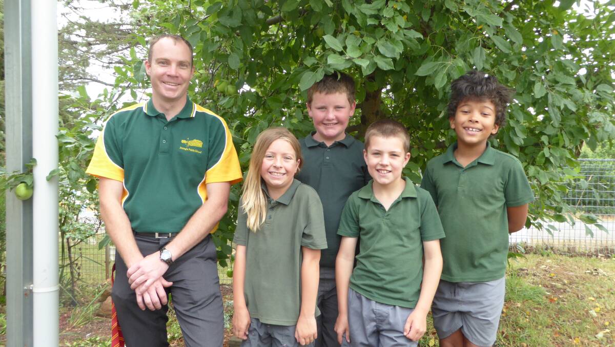 Milestone: Jerangle Public School's relieving principal with half of the school's students, as they get ready to mark 125 years. Photo: Supplied