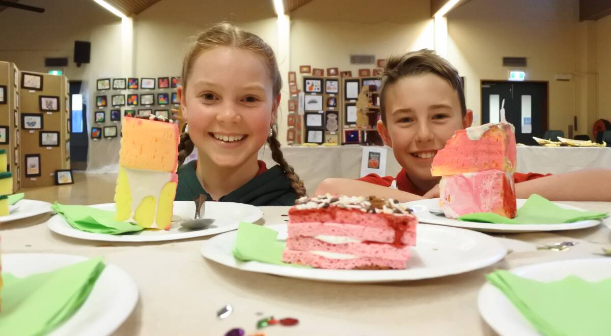 Art's a piece of cake: Macgregor Primary School captains Charlotte Jackson and Jordan Valter with food-based art work. Photo: Andrew Brown