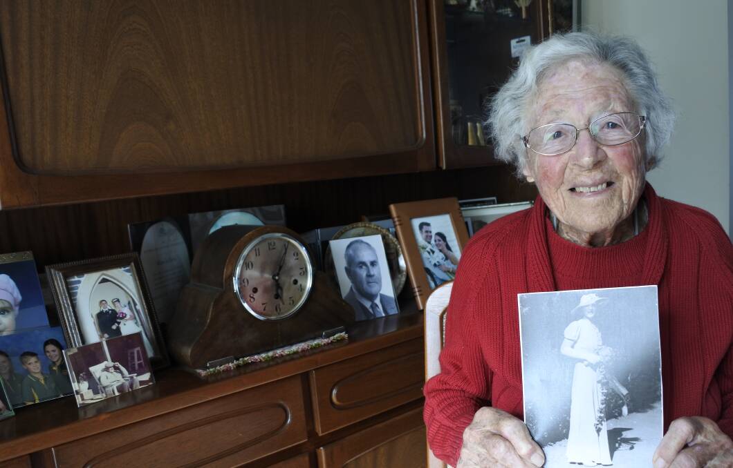 Triple figures: Sheilah Barrie with a photo of herself when she was 21. She will mark her 100th birthday on July 22. The Giralang resident has lived in Canberra since 1925. Photo: Andrew Brown