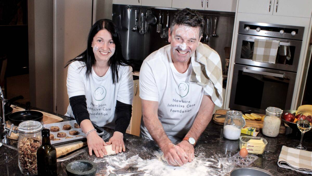 Baking for a cause: Bake for Babies coordinator Tina Martinovic and Newborn Intensive Care Foundation chair Peter Cursley putting their baking skills to the test. Photo: Supplied