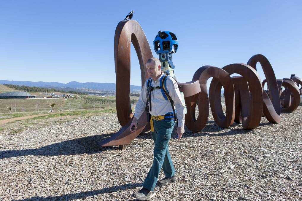 AMAZING VIEW: Joshua Thomson with the Google Trekker at the National Arboretum capturing the Wide Borwn Land sculpture. Photo: Andrew Tatnell Photography.