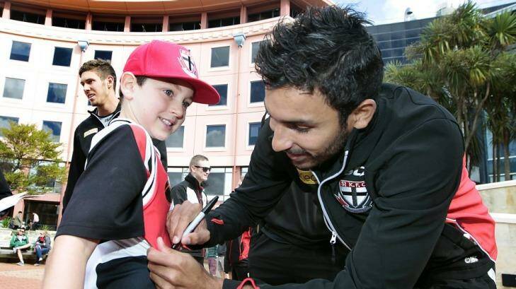 St Kilda's Trent Dennis-Lane with a young fan. Photo: Cameron Burnell