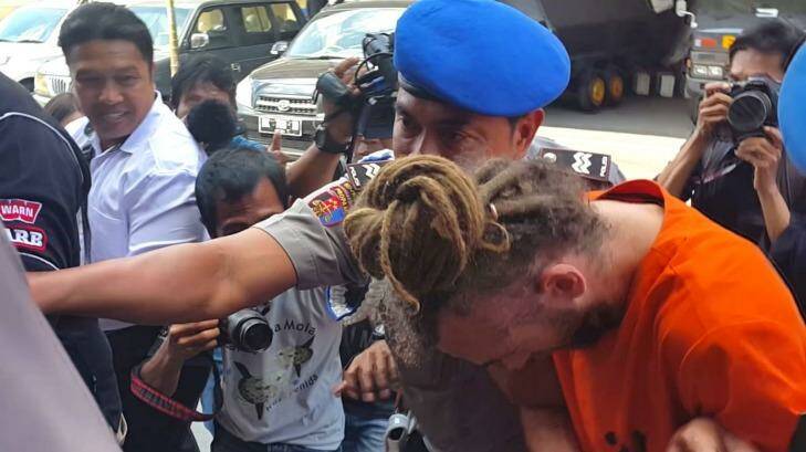 David Taylor is taken from his holding cell at Denpasar police station for interrogation. Photo: Amilia Rosa