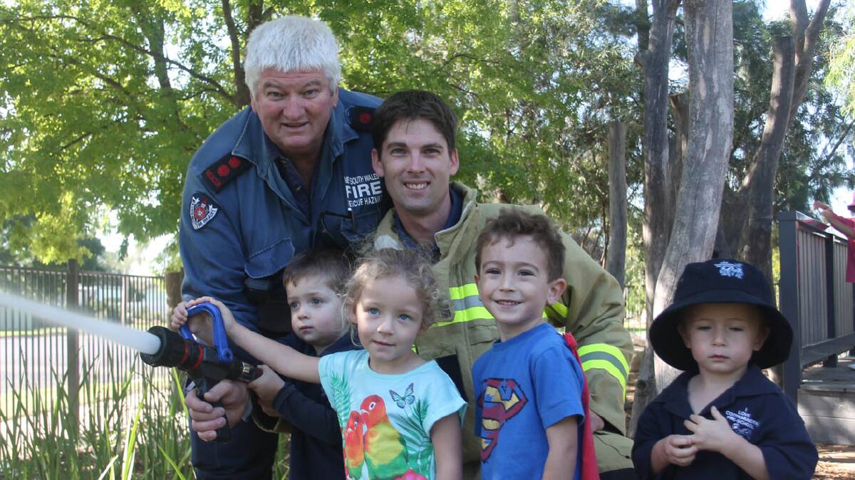 COOTAMUNDRA: Pictured demonstrating the Cootamundra Fire and Rescue hose are Captain Les Carr and Chris Carr and Cootamundra Pre School children Noah Carr, Lucy Smart, Darcy Thompson and Lucas Walker.