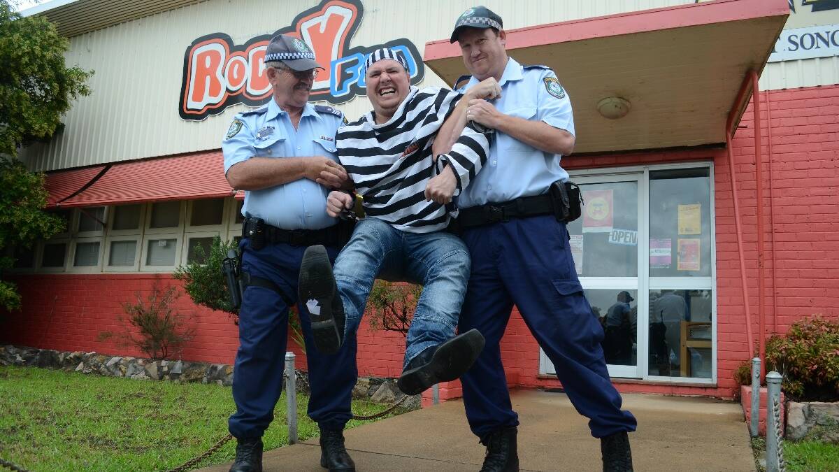 YOUNG: To the lock-up for Wes: The scenes outside 2LF and Roccy FM yesterday at noon were not pretty as Sergeant John Waples and Senior Constable Brendan Clark arrived to take local radio DJ Wes Heather into custody. But it was all in good fun, raising money for the Young Police Citizens Youth Club for their annual Time4Kids fundraiser.