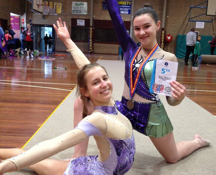 Queanbeyan YMCA Gymnastic's Kayla Cragg, pictured right from the Melbourne Nationals, took out the level seven NSW Country Championship in Rooty Hill, Sydney, last weekend.