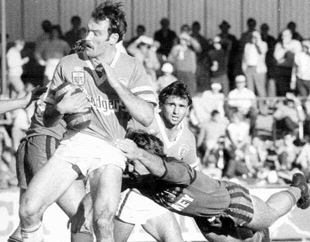 Canberra Raiders fullback Steve O Callaghan is stopped by a Norths Bears' player at Seiffert Oval in 1984. The Raider will return to their former home ground in Queanbeyan for a trial match next year.