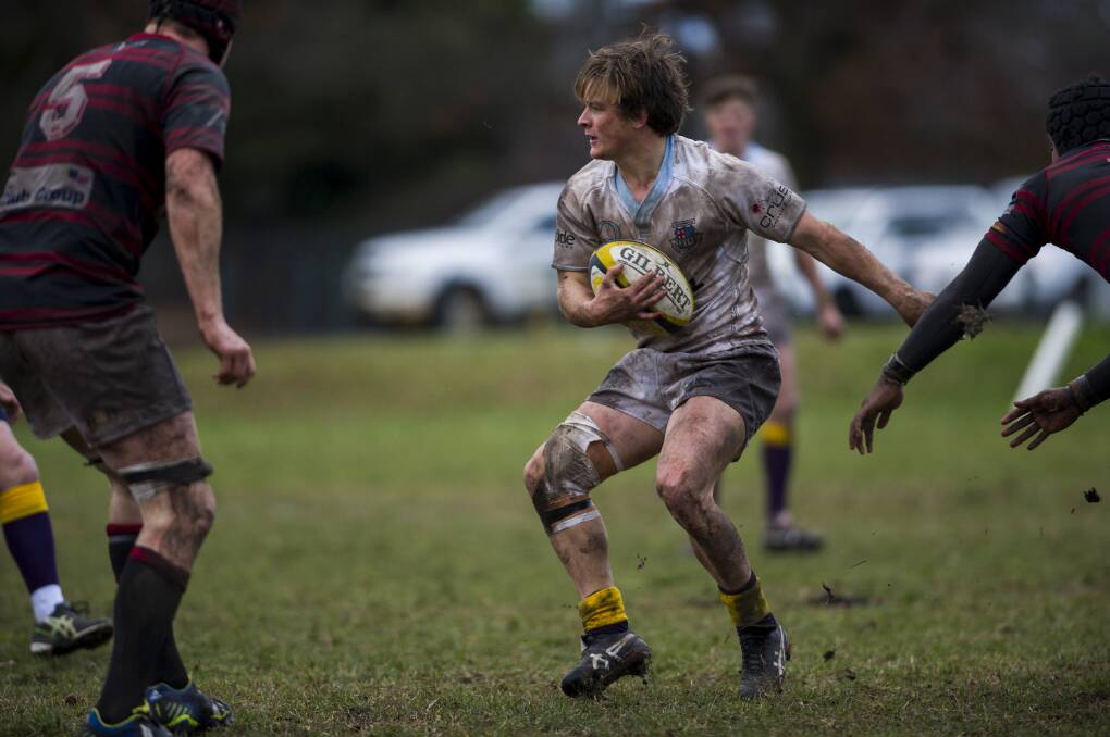Queanbeyan Whites player Billy Chalker in the muddy conditions at Campese Field playing against the Gungahlin Eagles last Saturday. Photo: Rohan Thomson.