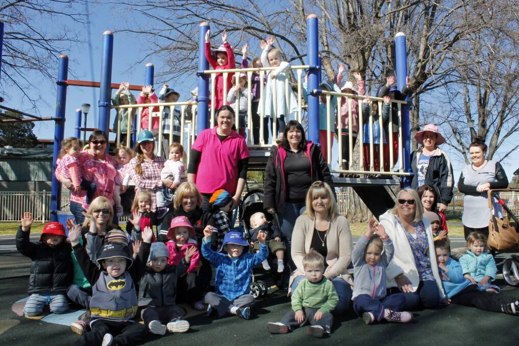 Peita Swaysland (centre, in pink) and local family day care educators rally in support of the community-based child care model, which is under threat due to funding cuts in this year's federal budget (PHOTO: David Butler).