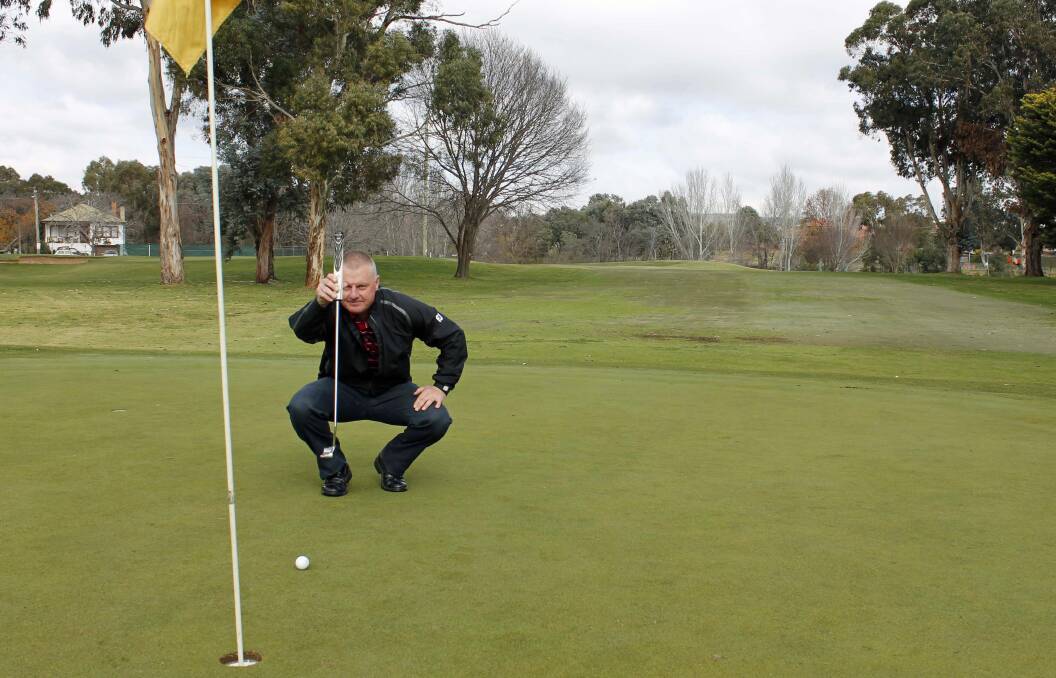 New Queanbeyan Golf Club CEO Glen Lloyd lines up a putt at the local Queanbeyan course.