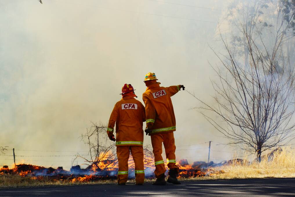 Firefighters battle a fire at Maiden Gully. Picture: LUKE WALLIS (CONTRIBUTED)