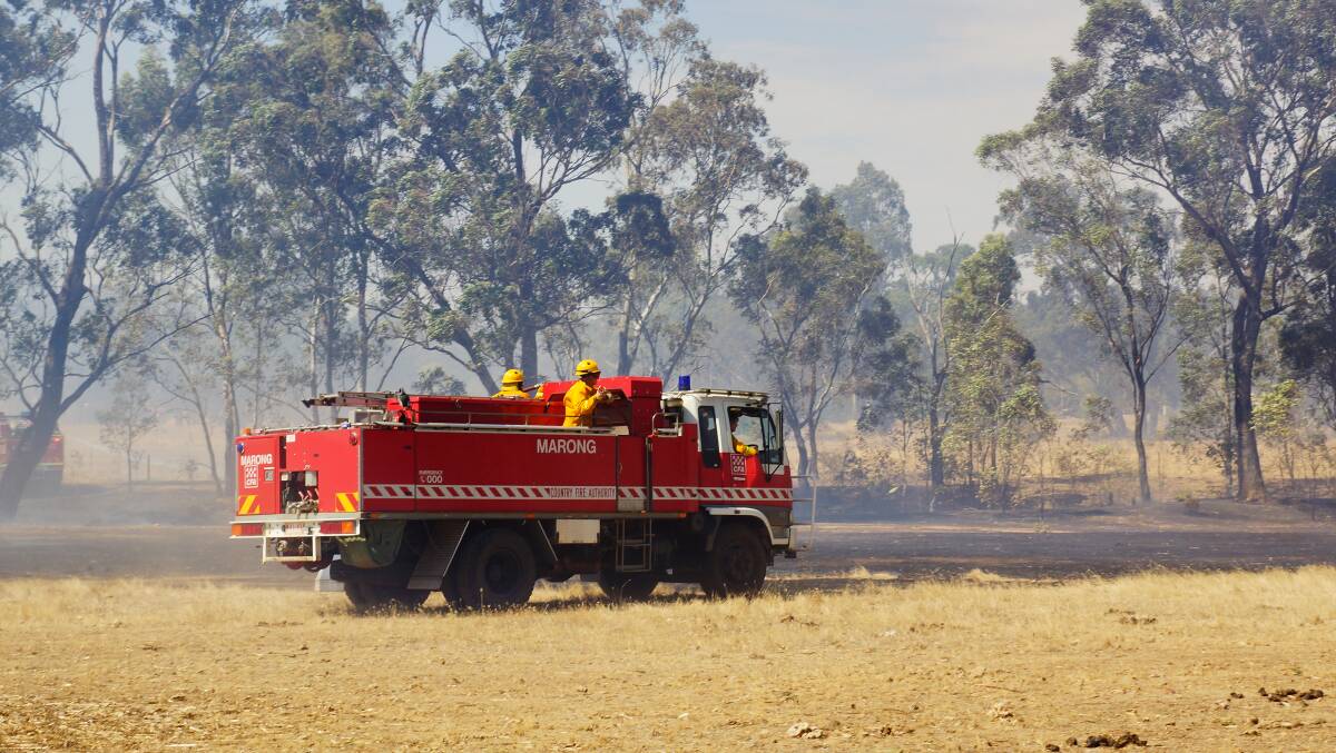 Firefighters battle a fire at Maiden Gully. Picture: LUKE WALLIS (CONTRIBUTED)