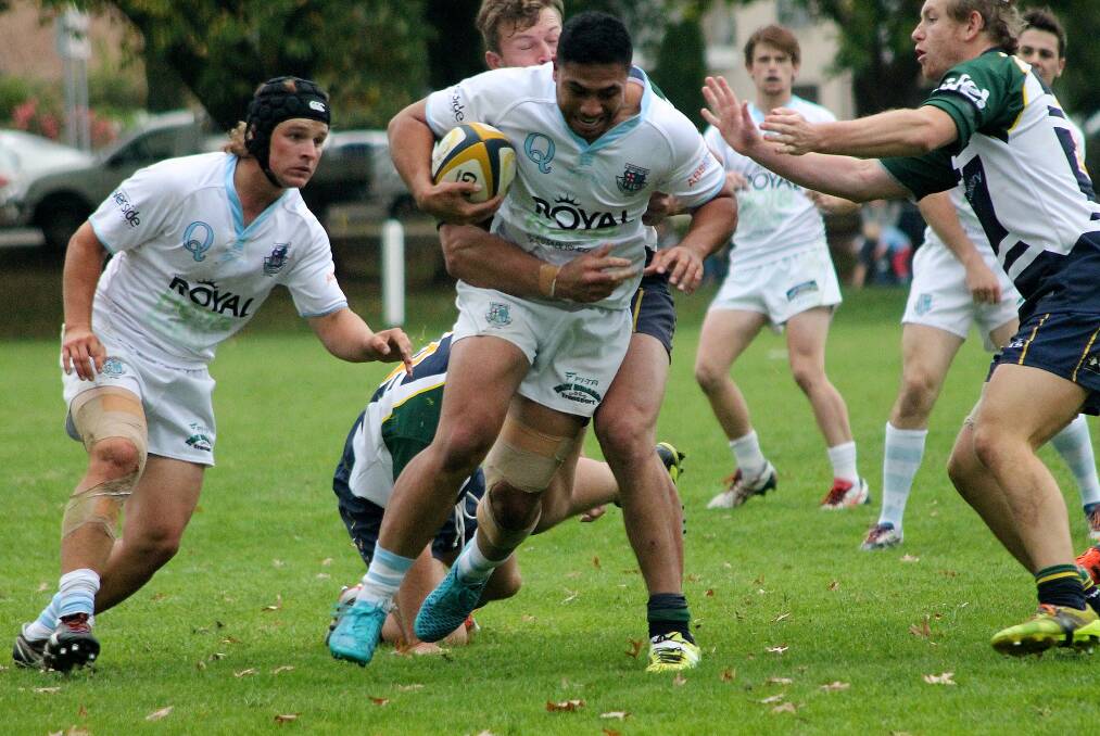 Whites's centre Lani Tiatia navigates the Owls pack in a physical affair at Campese Oval. Photo: Gemma Varcoe.