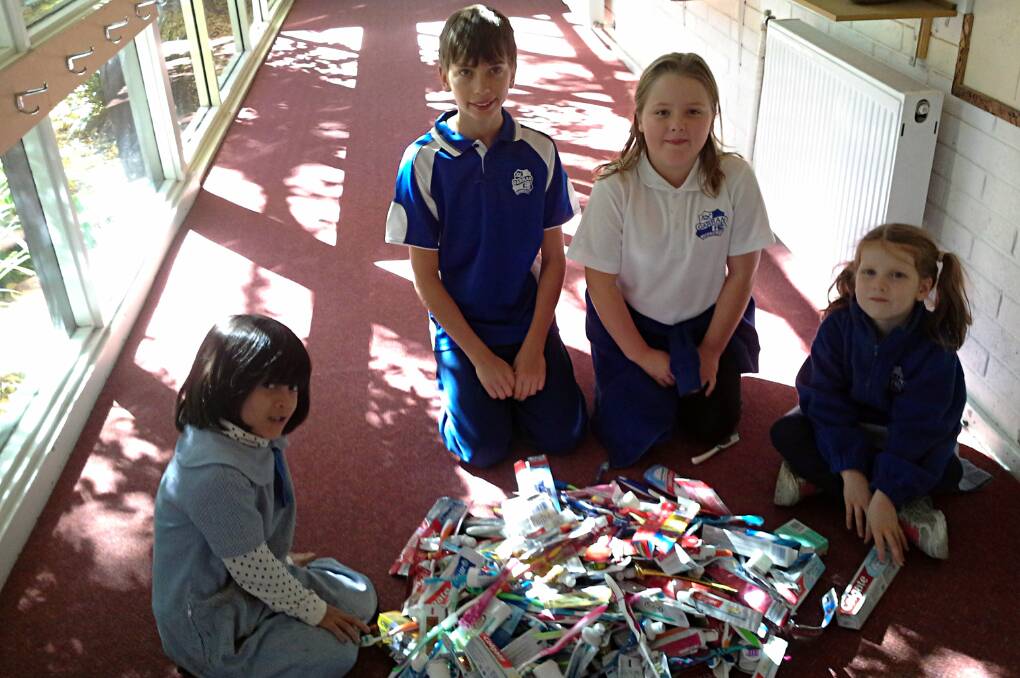 Garran Primary students Zola Freudenstein, Stepan Pohl, Rose Howard, and Olea Puric with a haul of oral care products ready to be recycled. Photo: Supplied