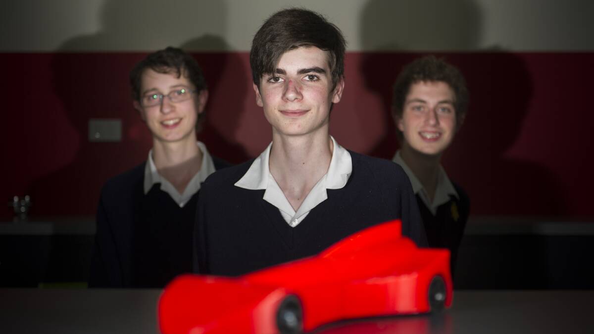 Rocket racer: Jack Williams, Guiseppe Rover and Matthew Williams of St Francis Xavier College have built a 3D printed rocket car called "The Stocktopus". Photo: Jay Cronan