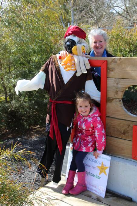 Erindale Neighbourhood Garden convenor Karen Macpherson and Lilian with a pirate inspired scarecrow. Photo: supplied.