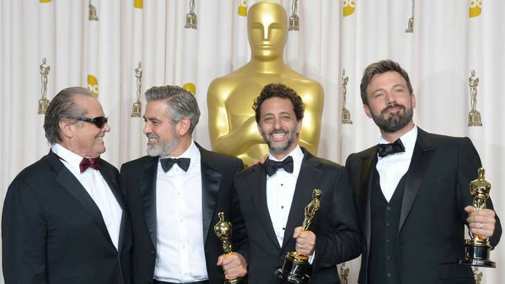 Ben Affleck (R), George Clooney (2nd L), Grant Heslov (2nd R) and presenter Jack Nicholson celebrate winning the trophy for Best Picture for Argo at the 85th Annual Academy Awards.