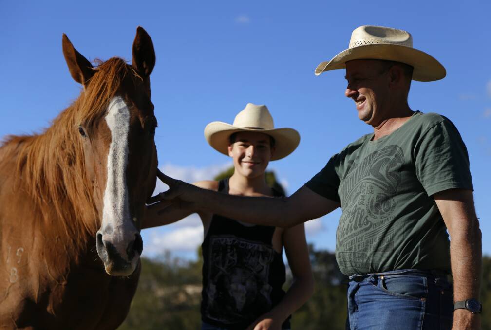 Father and son Brett and Casey Woodbridge with one of their 40 rodeo horses Too Hot to Touch on their property outside Bungendore. The Woodbridges will be supplying bareback and saddle bronc horses for this weekend's Queanbeyan Rodeo. Photo: Andrew Johnston