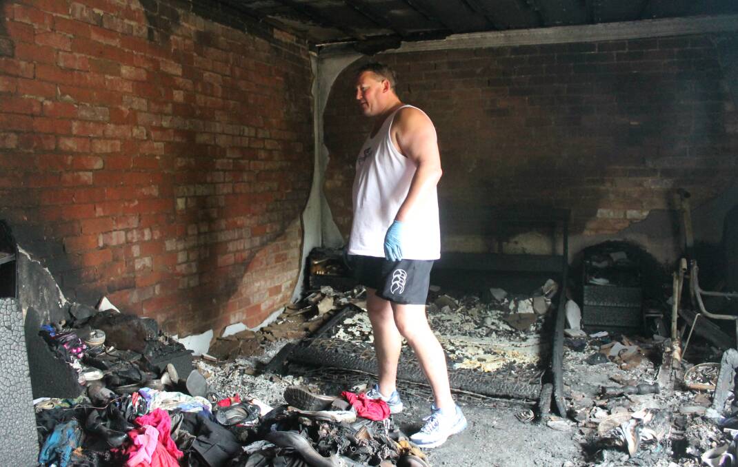 Queanbeyan man Darren Harris surveys the ruins of his burnt out Cassidy Street unit. Photos: Andrew Johnston, Queanbeyan Age