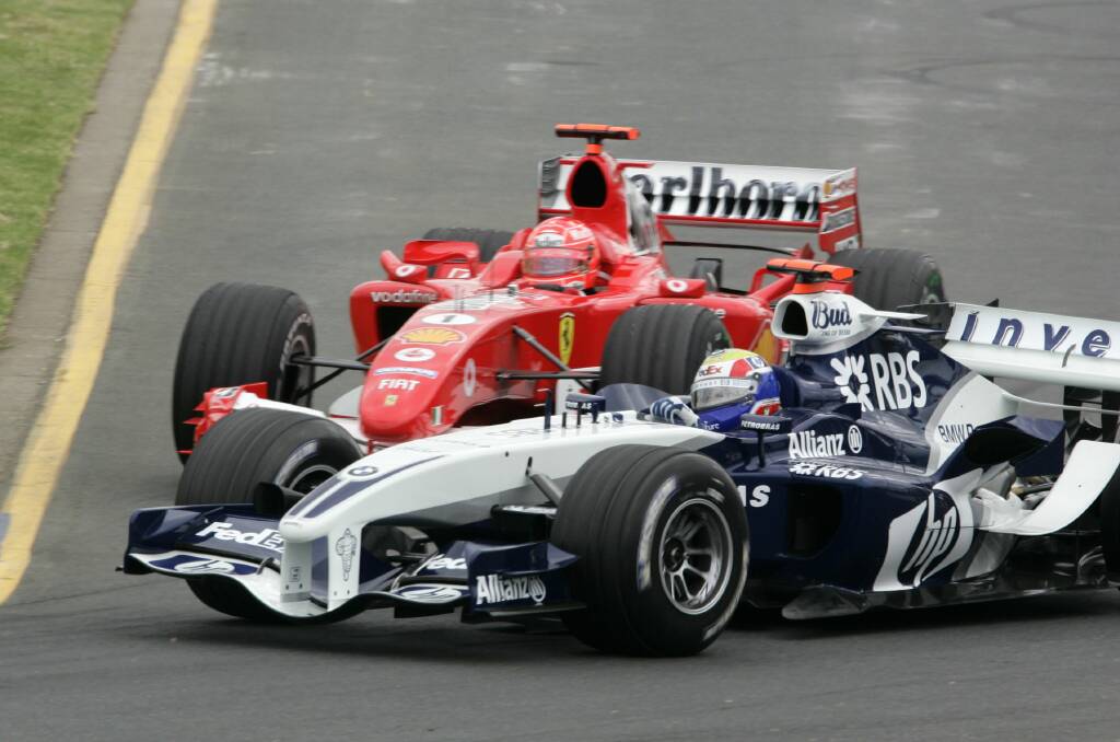 Mark Webber, then racing for Williams, cuts off Ferrari great Michael Schumacher during practice at the 2005 Australian Grand Prix. Photo: Fairfax Media