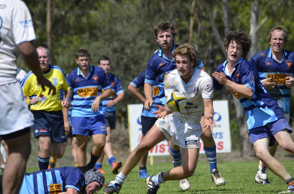 Queanbeyan Whites player Daniel Naeff gets the ball away during his side's heavy pre-season loss to representative side Central West last weekend. Photo: Andrew Johnston